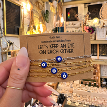 Load image into Gallery viewer, Gold and silver evil eye matching bracelets on a Let's Keep An Eye On Each Other card - Let's Jam, Camden Market, London
