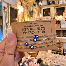 Load image into Gallery viewer, Gold and silver evil eye matching bracelets on a Let's Keep An Eye On Each Other card - Let's Jam, Camden Town
