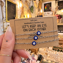 Load image into Gallery viewer, Three silver evil eye matching bracelets on a Let's Keep An Eye On Each Other card - Let's Jam, Camden Town
