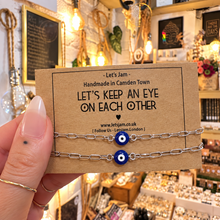 Load image into Gallery viewer, Two silver evil eye matching bracelets on a Let's Keep An Eye On Each Other card - Let's Jam, Camden Town
