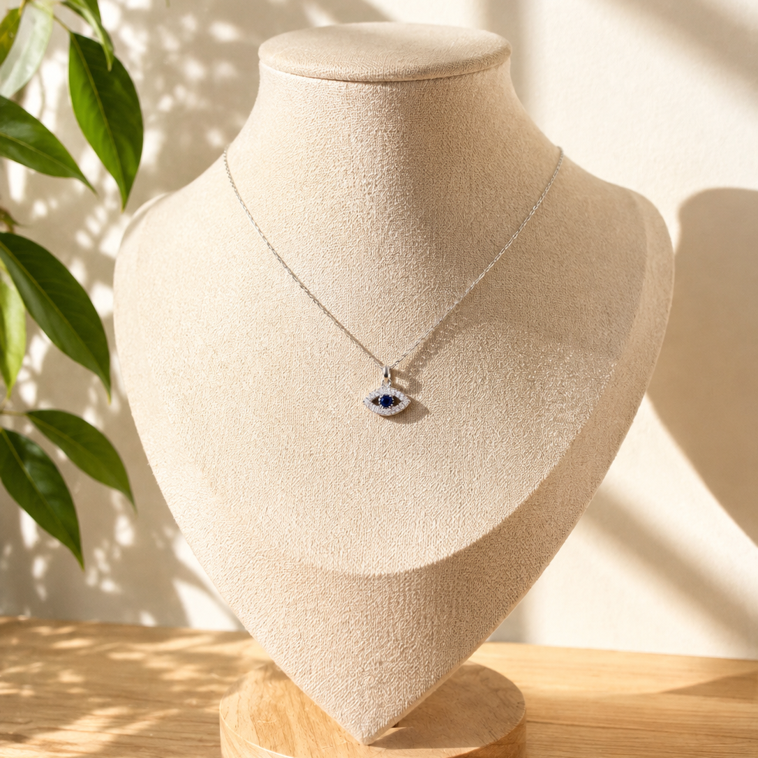 Close-up of the evil eye charm, blue and white stones set in a slim frame - Let's Jam jewellery, Camden Market London
