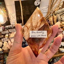 Load image into Gallery viewer, Fire quartz crystal freeform held in the hand in the shop - Let's Jam, Camden Town
