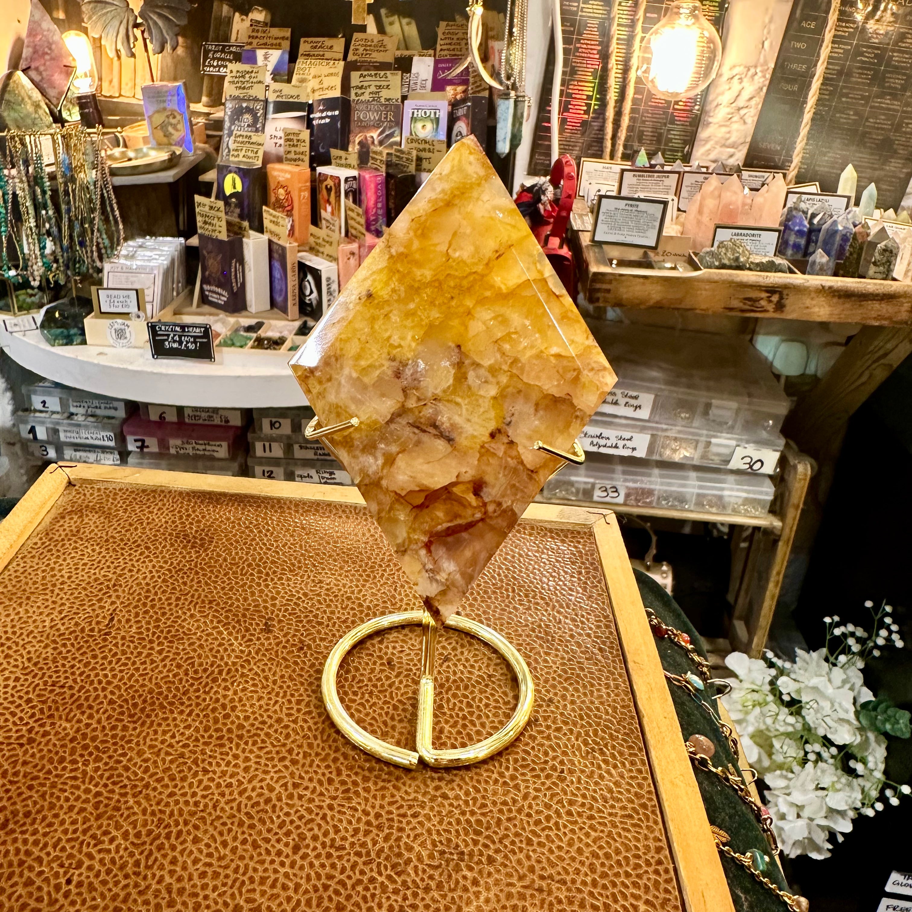 Fire quartz crystal point on its own stand with warm red hematite flashes - Let's Jam, Camden Market