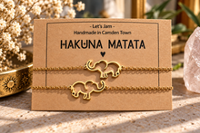 Load image into Gallery viewer, Two matching silver chain bracelets with elephant charms on a Hakuna Matata display card - Let's Jam jewellery, Camden Town
