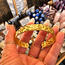 Load image into Gallery viewer, Front of the textured gold cuff held up - Let's Jam, Camden Market
