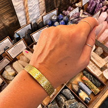 Load image into Gallery viewer, Hammered gold cuff bangle worn on the wrist - Let's Jam, Camden Market
