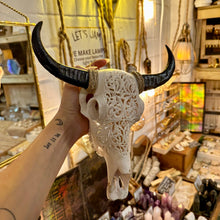 Load image into Gallery viewer, Hand carved white buffalo skull with dark horns on display in the shop - Let's Jam, Camden Market
