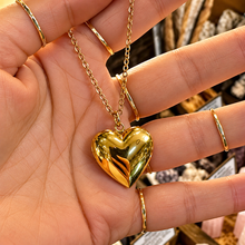 Load image into Gallery viewer, Gold puffed heart locket held in the hand - Let's Jam jewellery, Camden Market London
