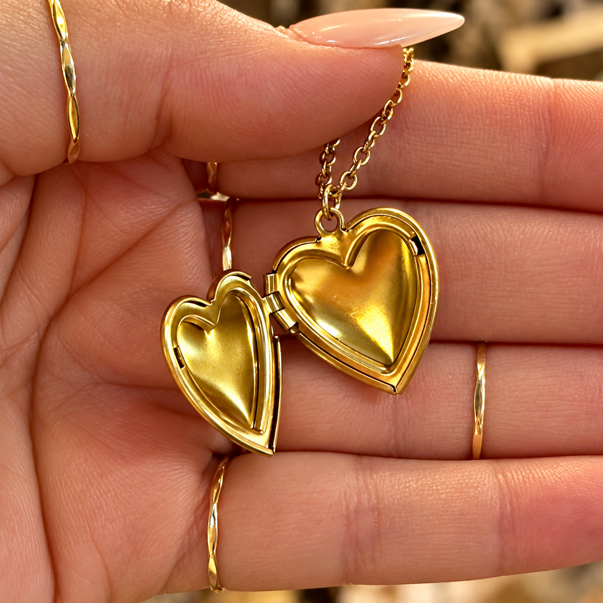 Gold heart locket opened in the hand - Let's Jam, Camden Town