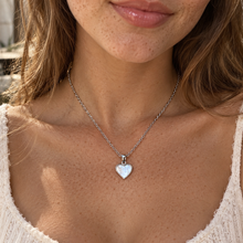 Load image into Gallery viewer, Silver mother of pearl heart necklace worn with a white top - Let's Jam, Camden Market, London
