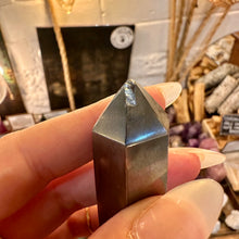 Load image into Gallery viewer, Close-up of a hematite tower showing the small chip on its tip - Let's Jam, Camden Town London
