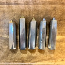 Load image into Gallery viewer, Five shiny silver-grey hematite towers lying on a wooden table - Let's Jam, Camden Market
