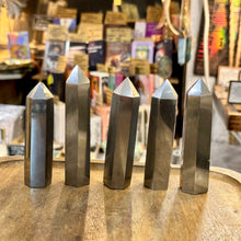 Load image into Gallery viewer, Five polished hematite towers standing in a row in the shop - Let's Jam, Camden Town
