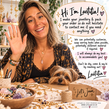 Load image into Gallery viewer, Laetitia waving at her workbench with her Yorkie, offering to customise chains and adjust lengths - Let's Jam, Camden Market London
