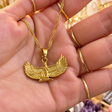 Load image into Gallery viewer, Gold winged goddess Isis pendant necklace held in the hand - Let's Jam, Camden Market
