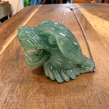Load image into Gallery viewer, Side view of a roaring green jade tiger head pendant on wood - Let's Jam jewellery, Camden Market, London
