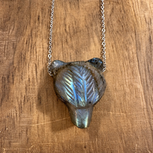 Load image into Gallery viewer, Labradorite bear head pendant on a silver chain laid on wood - Let's Jam, Camden Market
