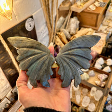 Load image into Gallery viewer, Labradorite butterfly held up to show the carved detail on the wings - Let's Jam, Camden Market London
