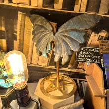 Load image into Gallery viewer, Labradorite butterfly on its gold stand beside a vintage light bulb - Let's Jam, Camden Market, London
