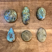Load image into Gallery viewer, Carved labradorite cabochons flashing blue and green in natural light - Let's Jam, Camden Market, London
