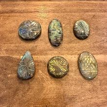 Load image into Gallery viewer, Carved labradorite cabochons showing golden flashes on a wooden table - Let's Jam, Camden Town
