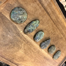 Load image into Gallery viewer, Carved labradorite cabochons laid in a diagonal line on a wooden tray - Let's Jam, Camden Market London
