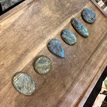 Load image into Gallery viewer, Row of six carved labradorite cabochons on a wooden tray, seen from the other end - Let's Jam, Camden Town London

