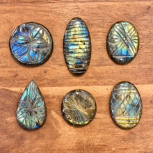 Load image into Gallery viewer, Six hand carved labradorite cabochons with flower and stripe patterns on a wooden table - Let's Jam, Camden Market
