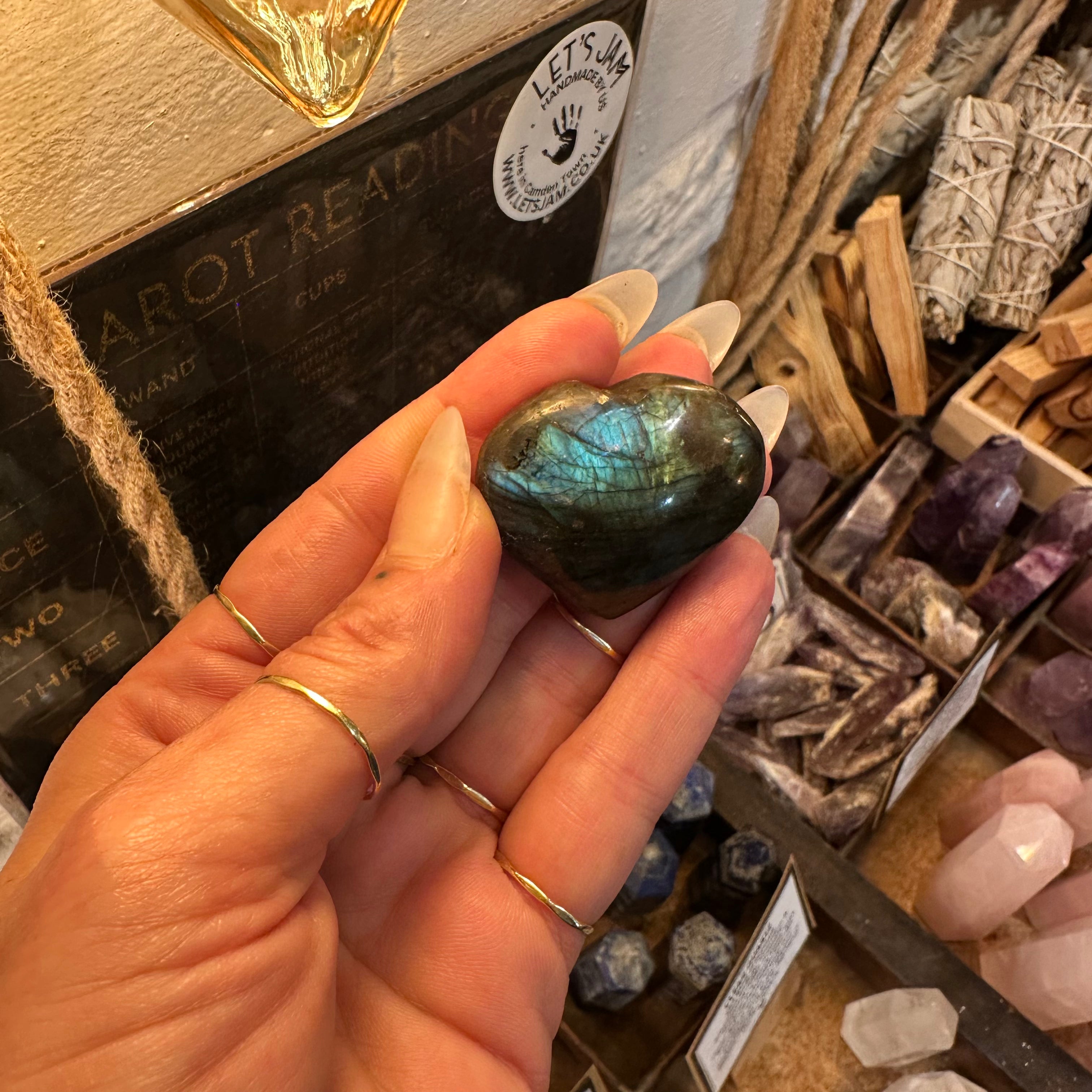 Small labradorite heart held between the fingers to show its size - Let's Jam, Camden Town London
