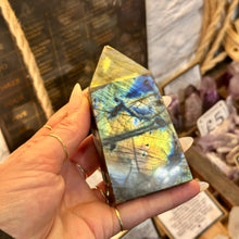 Load image into Gallery viewer, Labradorite point held at an angle to catch the light - Let's Jam, Camden Town

