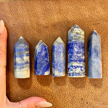 Load image into Gallery viewer, Lapis lazuli towers six to ten next to a hand to show their size - Let's Jam, Camden Town London
