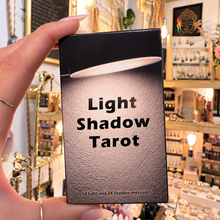 Load image into Gallery viewer, Light Shadow Tarot black box held in the hand in the shop - Let's Jam, Camden Market
