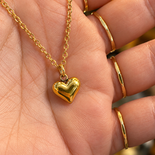 Load image into Gallery viewer, Gold puffed love heart pendant held in the hand - Let's Jam, Camden Market, London
