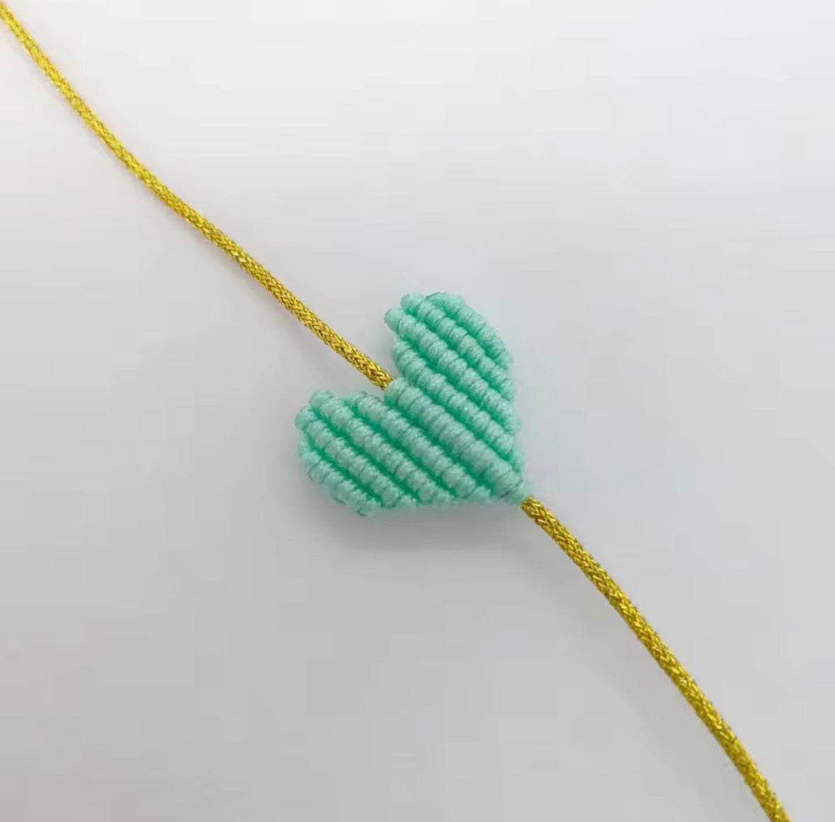 Mint green macramé heart bracelet on a gold cord - Let's Jam, Camden Town
