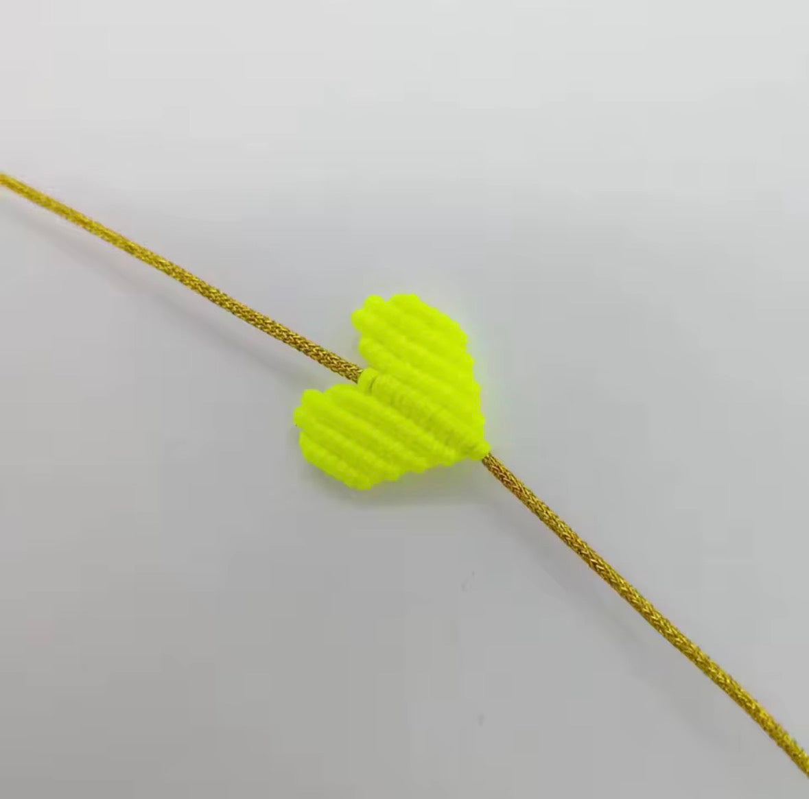 Neon yellow macramé heart bracelet on a gold cord - Let's Jam, Camden Market, London