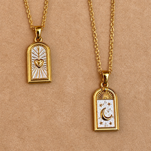 Load image into Gallery viewer, Gold heart and moon arch pendants side by side on chains - Let's Jam, Camden Market, London
