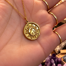 Load image into Gallery viewer, Gold moon and sun medallion held in the hand - Let's Jam jewellery, Camden Market
