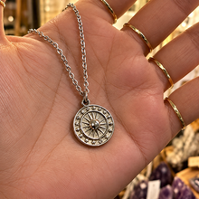 Load image into Gallery viewer, Silver sun and moon medal held in the hand - Let's Jam, Camden Market
