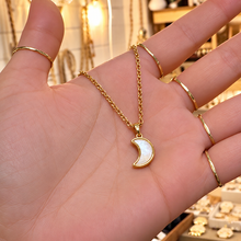 Load image into Gallery viewer, Gold mother of pearl crescent moon necklace held in the hand - Let's Jam, Camden Market
