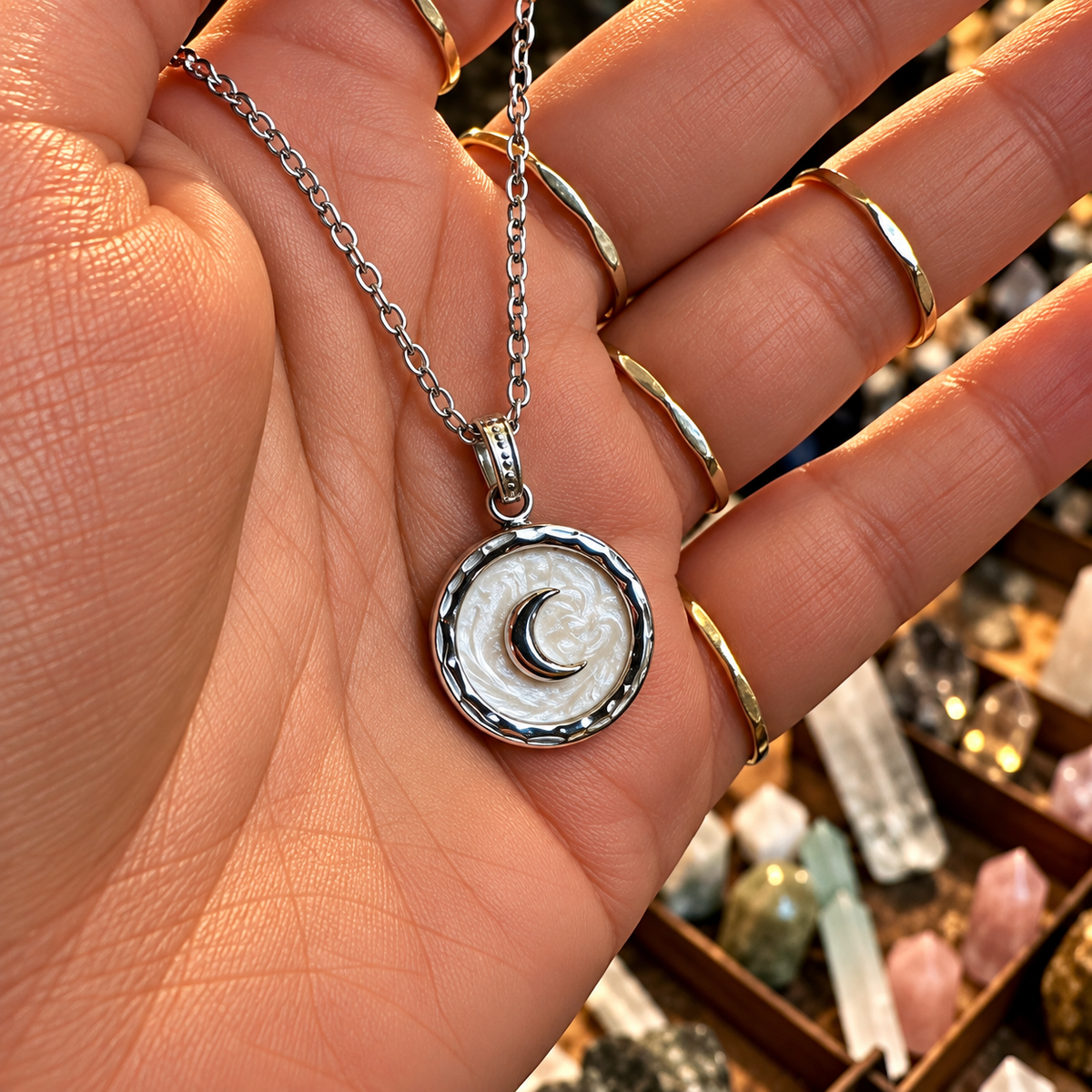 Silver round pendant with a crescent moon held in the hand - Let's Jam, Camden Market, London