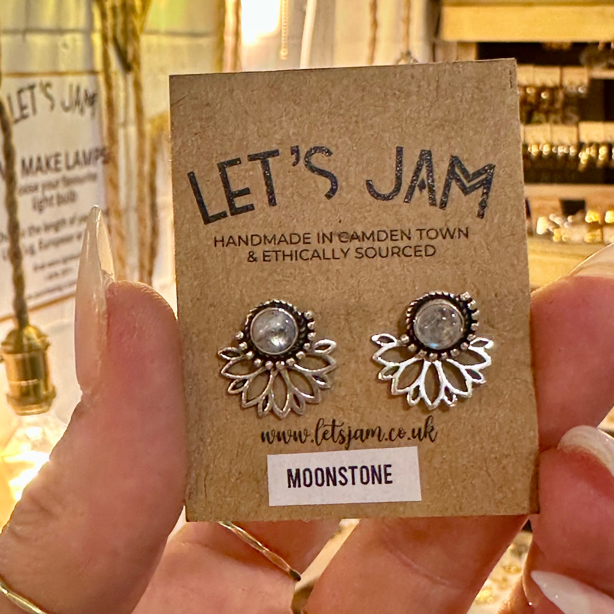 Moonstone lotus stud earrings on their gift card held in the hand - Let's Jam, Camden Market London