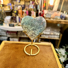 Load image into Gallery viewer, Moss agate heart on stand photographed in the shop - Let's Jam, Camden Market, London
