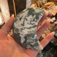 Load image into Gallery viewer, Moss agate moon held in the hand to show its size - Let's Jam, Camden Town London
