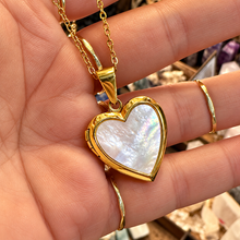 Load image into Gallery viewer, Gold mother of pearl heart locket held in the hand - Let's Jam, Camden Town London
