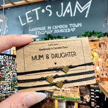 Load image into Gallery viewer, Black cord bracelet with a gold heart charm on a Let's Jam "Mum &amp; Daughter" card - Let's Jam, Camden Town London
