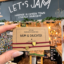 Load image into Gallery viewer, Two burgundy cord bracelets with gold heart charms on a Let's Jam "Mum &amp; Daughter" card - Let's Jam, Camden Market, London
