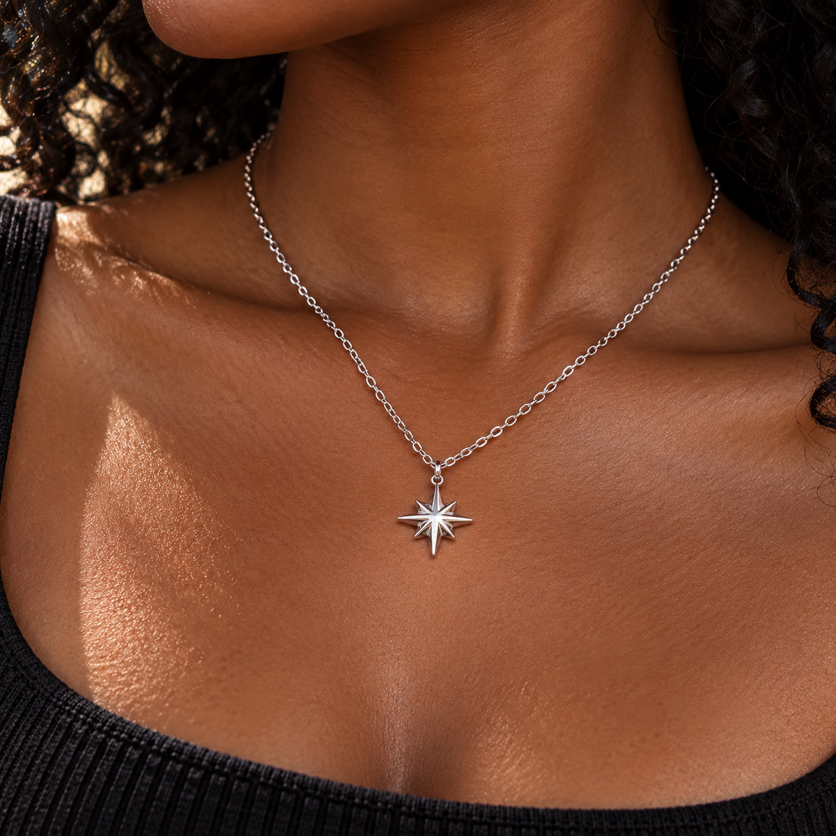 Silver northern star pendant necklace worn with a black top - Let's Jam jewellery, Camden Town London