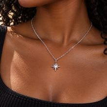 Load image into Gallery viewer, Silver northern star pendant necklace worn with a black top - Let's Jam jewellery, Camden Town London
