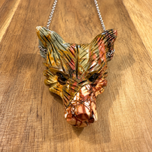Load image into Gallery viewer, Hand carved Picasso jasper wolf head on a silver chain laid on wood - Let's Jam jewellery, Camden Town

