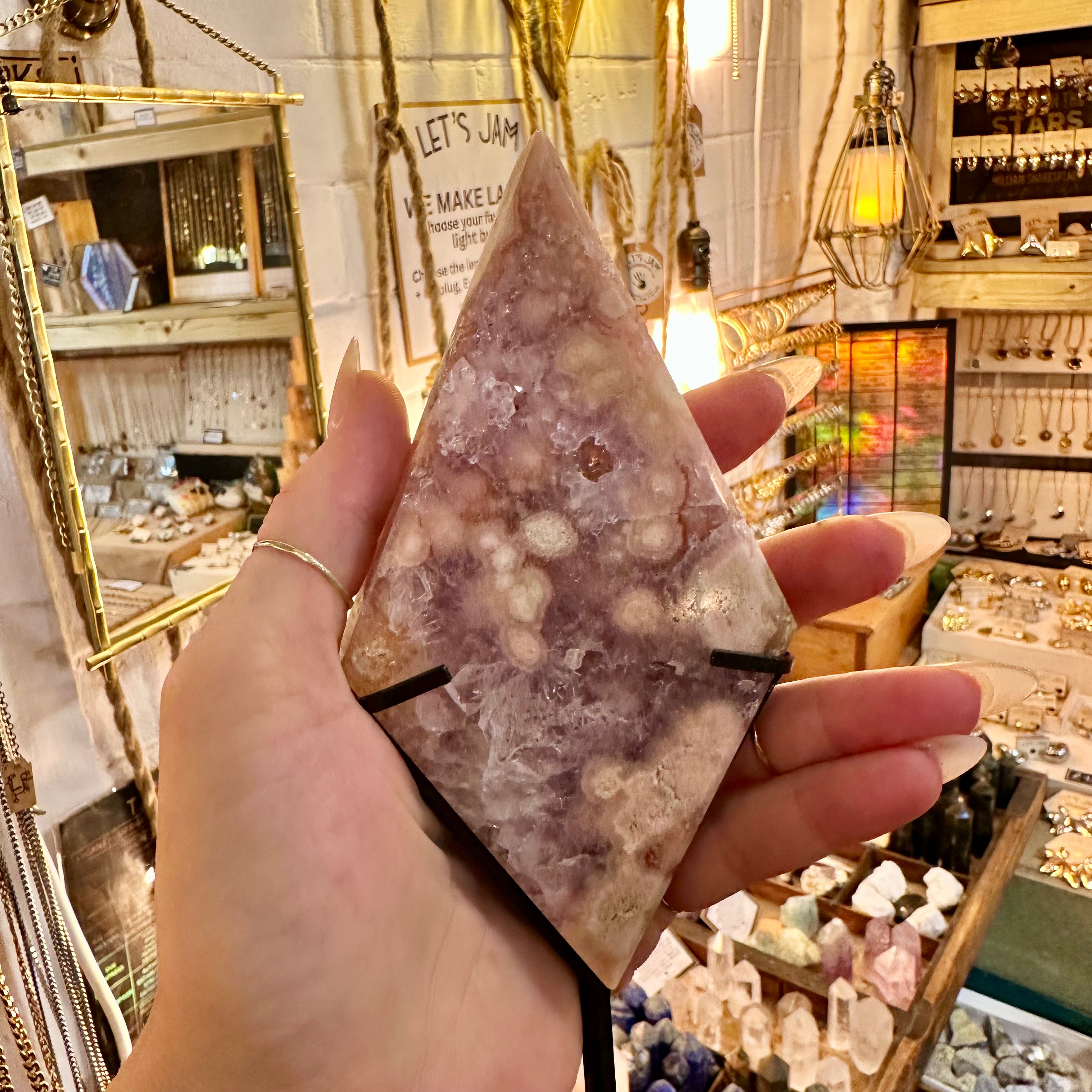 Side view of the pink amethyst standing on its metal stand - Let's Jam, Camden Town